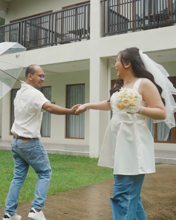 Twirling together under an umbrella