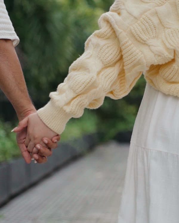 Holding hands on a garden walk