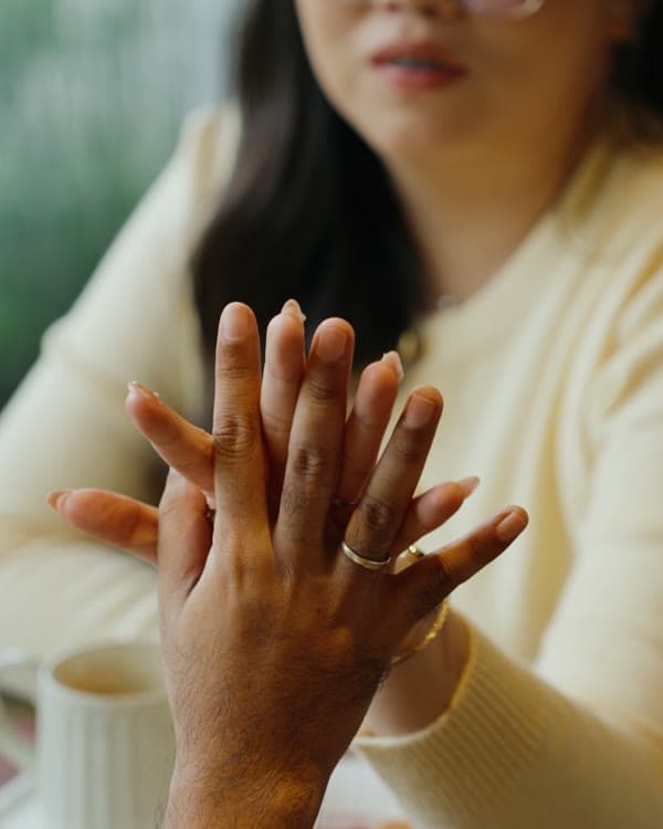 Hands together over coffee